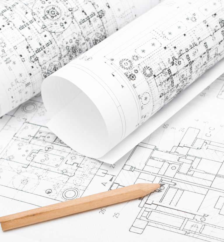 Various rolls of draft paper with schematic drawings and a single sharp pencil.