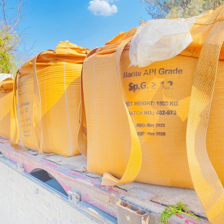 a truck with a large amount of bags of sandbags on the back of it