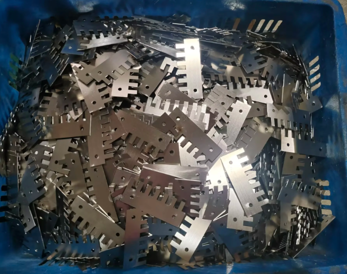 Precision laser cutting metal components and industrial steel parts piled