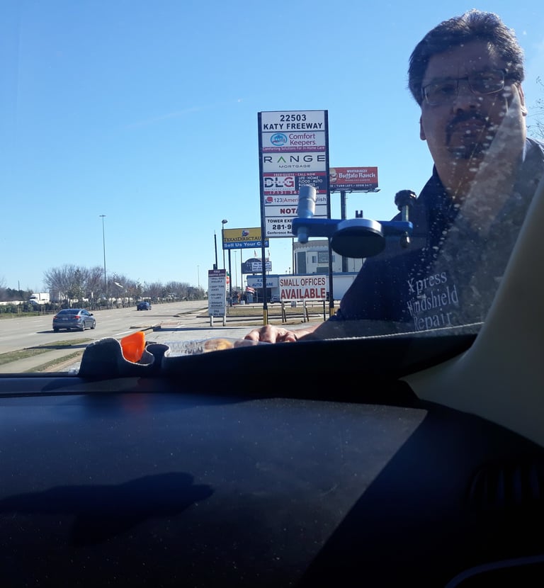 a man in a black shirt is driving a car