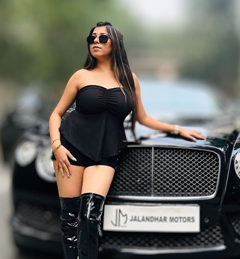 a woman in a black dress and boots is posing for a picture