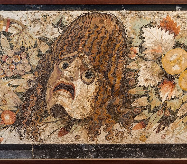 Tragic mask, detail of an ancient roman mosaic. Pompeii, Italy.