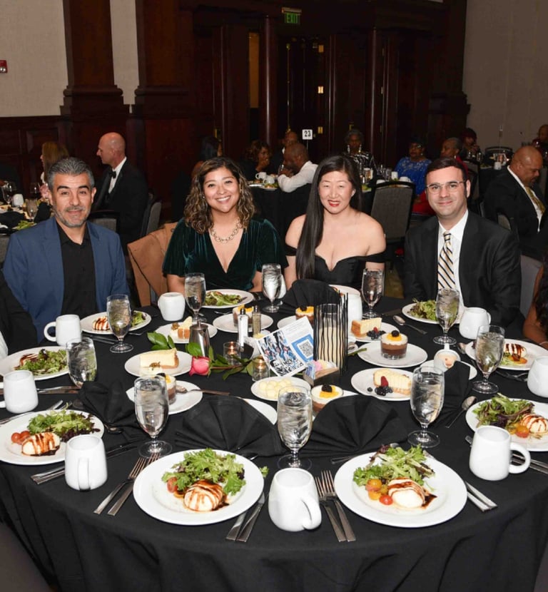 a group of people sitting around a table with plates of food for GFW MLK Jr. Community Event