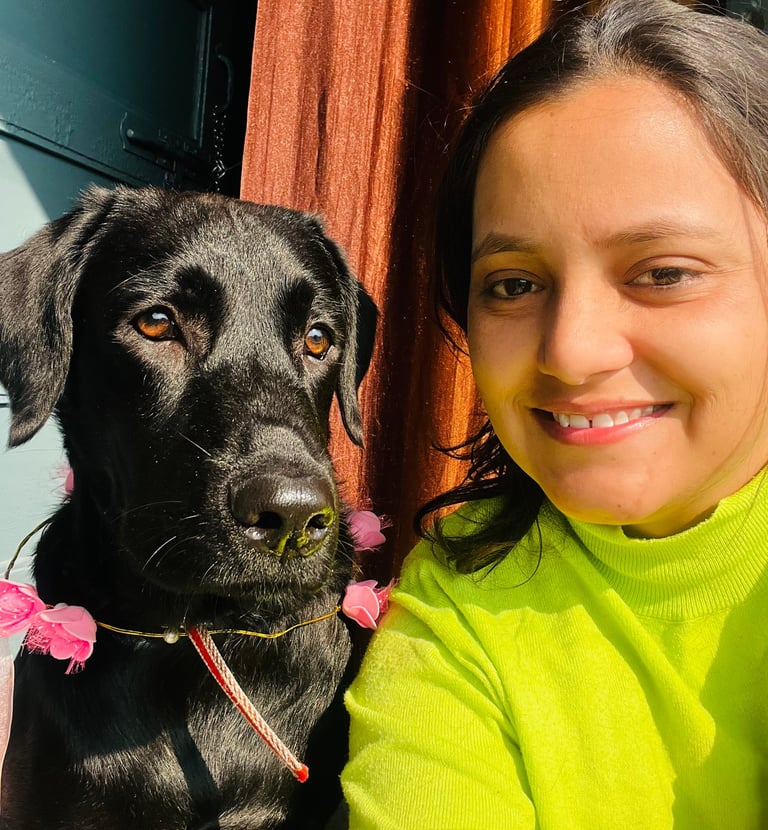 a woman in a green sweater and a black dog