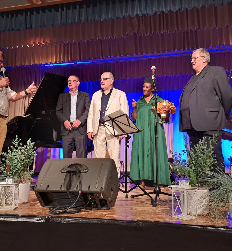 a group of people standing on a stage with a microphone