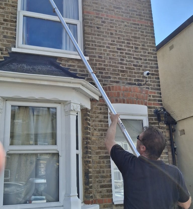 Gutter cleaning a two story house in Hoddesdon