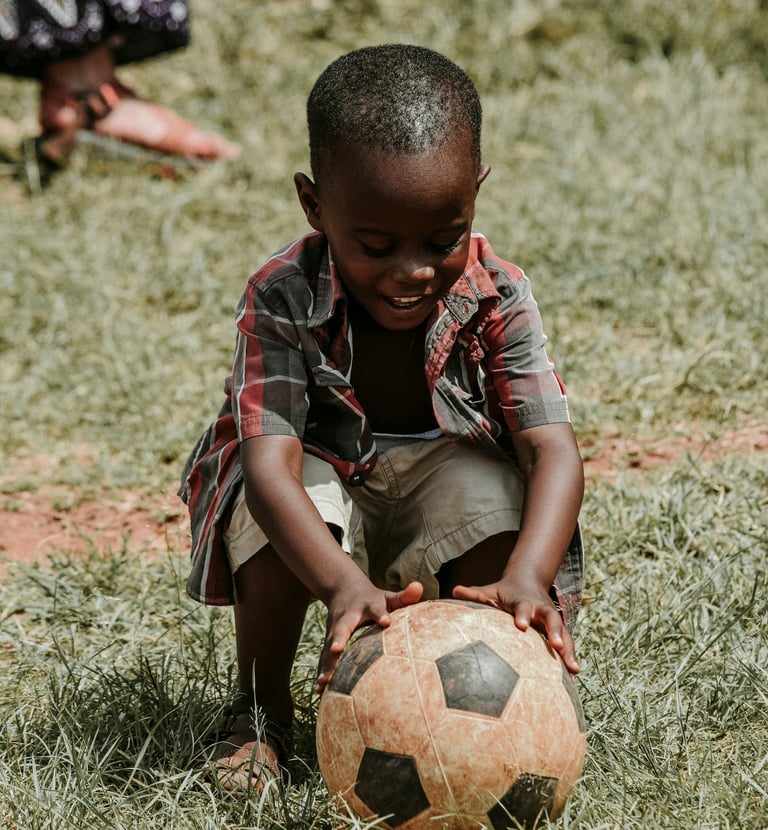 A young boy playing football