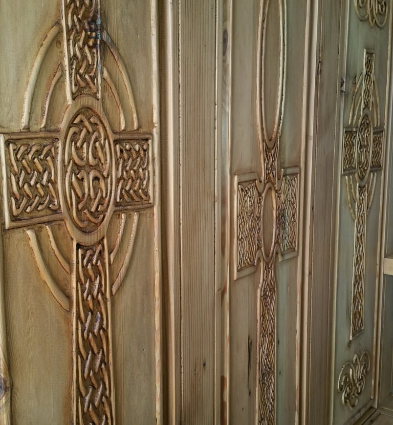 back panel of handcrafted monks bench.  Three carved panels featuring intricate Celtic knot crosses. Colorado Springs.