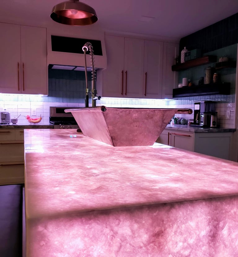Kitchen remodel highlighting translucent quartz waterfall island countertop with color changing LED lights underlaid.  