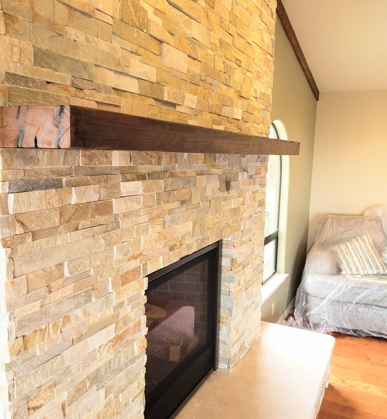 stone work fireplace surround with reclaimed beam mantle and slate hearth. Colorado Springs updated fireplaces.