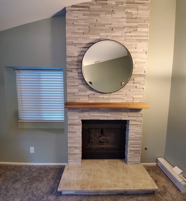 Stone work fireplace surround with reclaimed wood beam mantle, granite hearth. Colorado Springs hearth work.