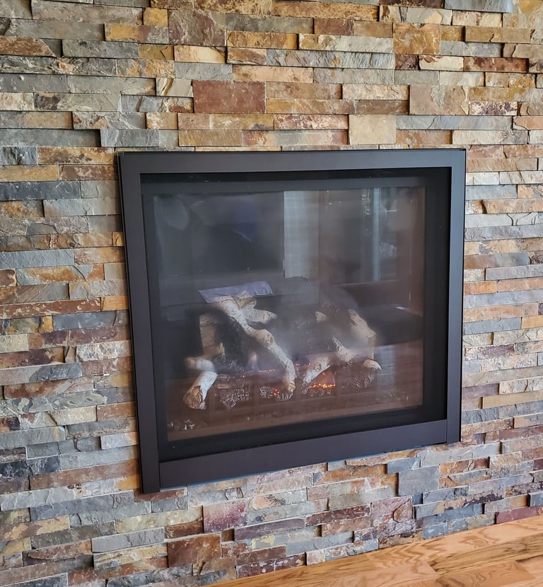 large gas fireplace with stone work surround. Colorado Springs fireplace remodel.
