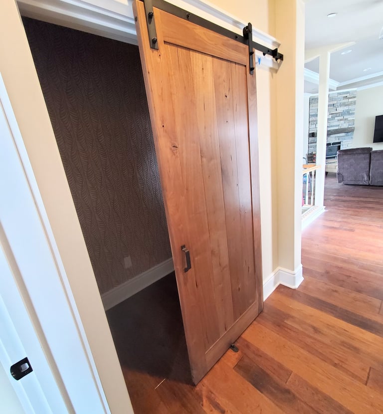 Sliding barn door in natural wood tones. Colorado Springs.