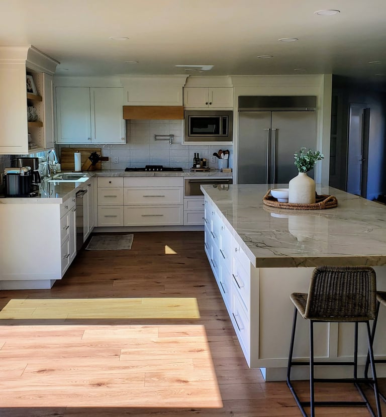 Open concept remodeled kitchen with long quartz counter center island. personalized kitchen remodels Colorado Springs. 