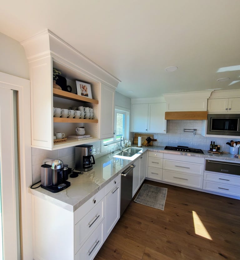 Coffee bar in renovated kitchen. LVP flooring and custom white shaker cabinets. Modern Kitchens Colorado Springs.