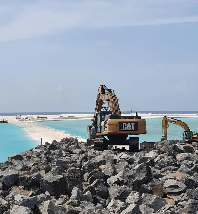 a construction worker is working on a beach with rock boulder's by swastika exim team in Maldives