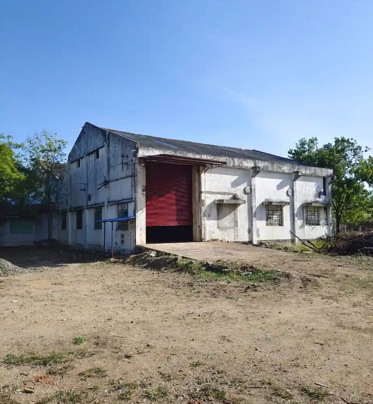 a warehouse with a red shutter door and a red door