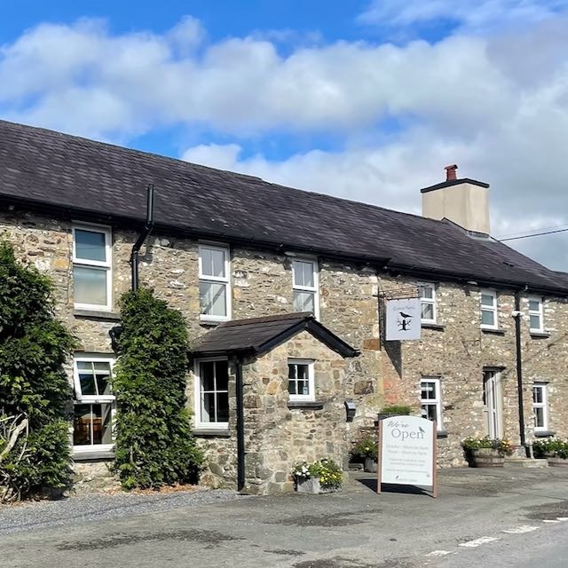 a stone building with a sign that says the name of the building