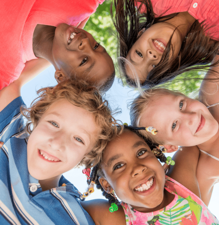 a group of smiling children standing in a circle