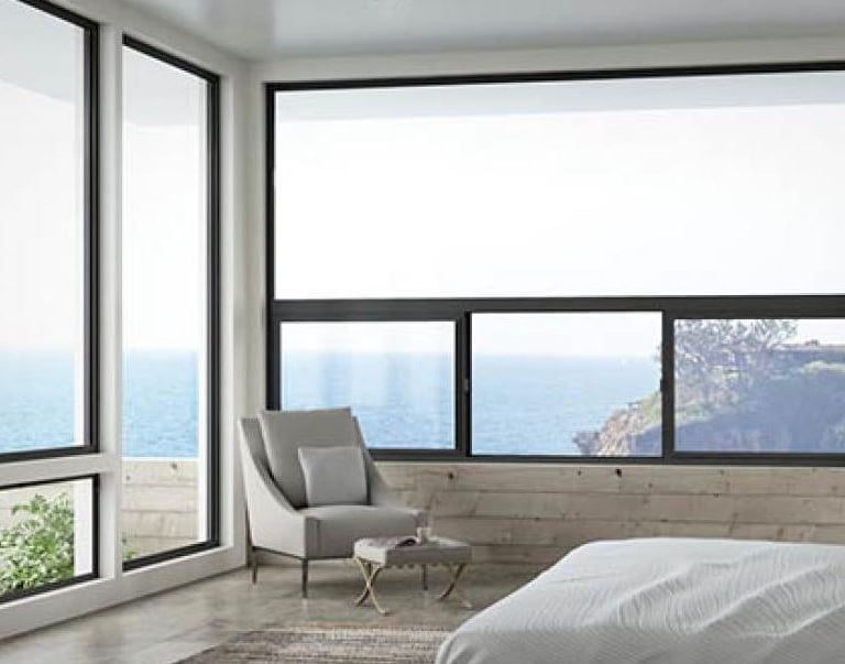 a bedroom with a large window and a chair