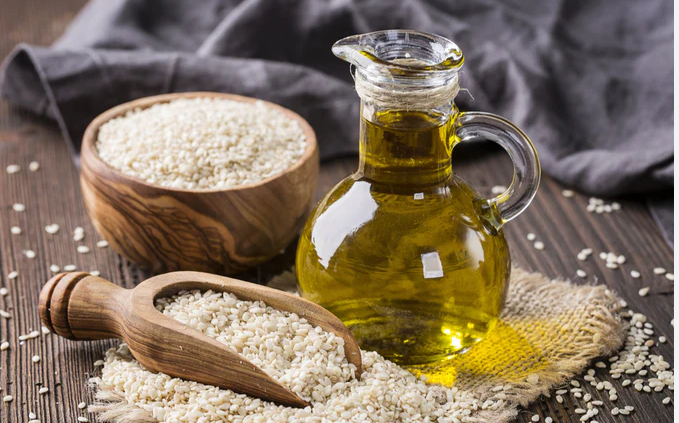 a bottle of rice brans and a wooden spoon with rice