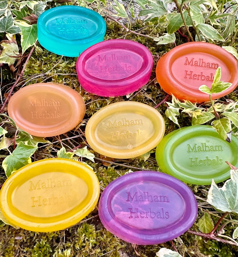 colourful unwrapped essential oil soaps on a natural background.