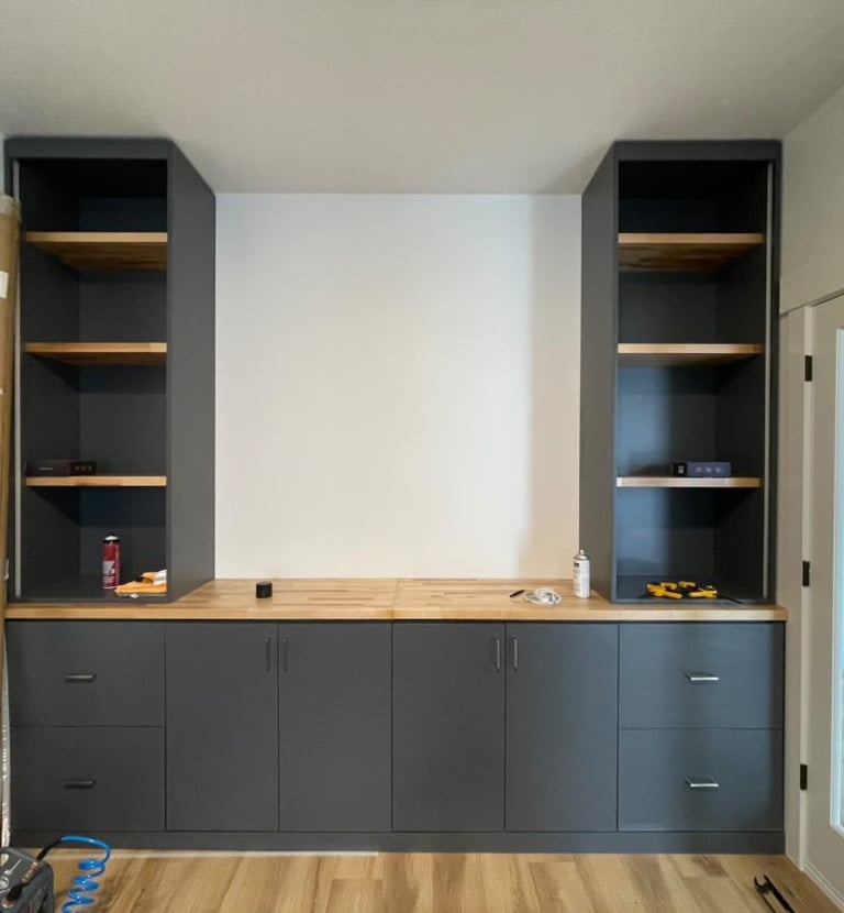 Custom-built storage unit by Portugal Woodworks in Utah, with a mix of open shelves and cabinets.