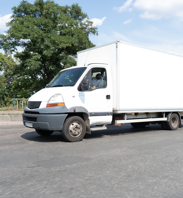 a white truck with a white boxy truck behind it