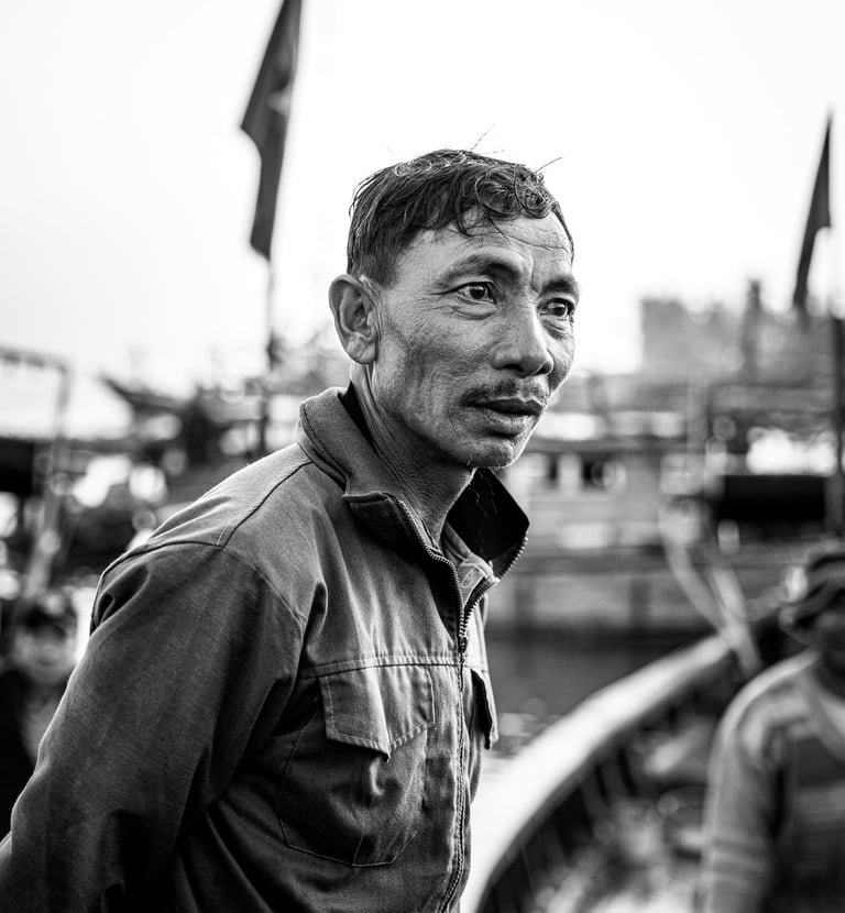 a black and white image of a fisherman in Vietnam