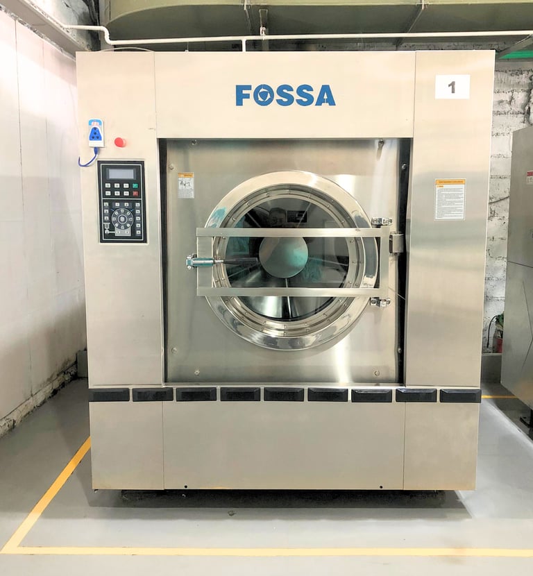 Industrial FOSSA heavy-duty commercial washing machine in a professional laundry facility.