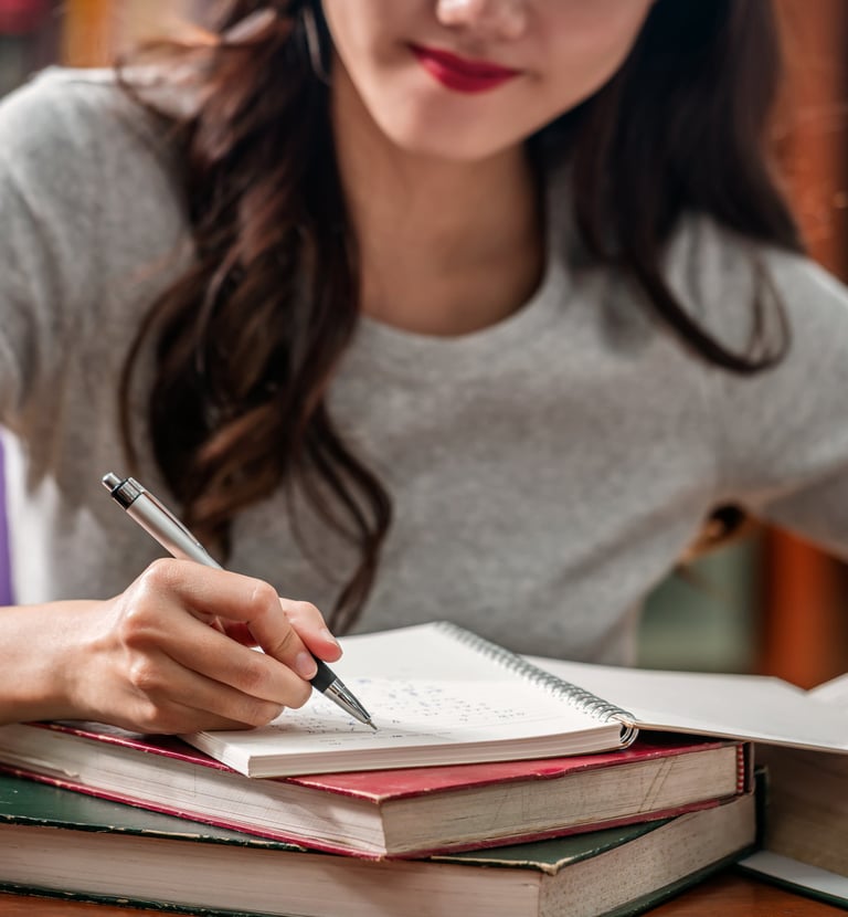 Image of an adult women writing in a notebook