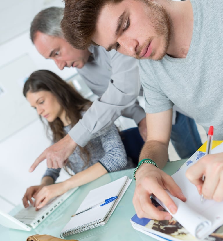 image of three adults studying