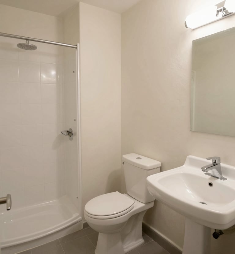 Bathroom with bright tiles, shower, and fresh towels neatly arranged.