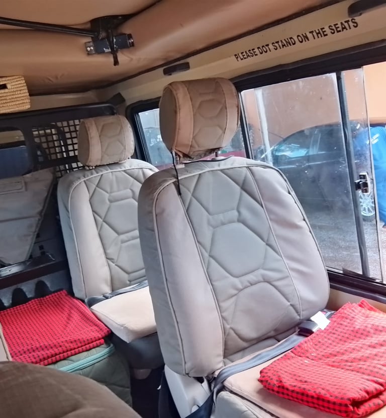 Interior of a safari tour vehicle with reclining, comfortable seats 