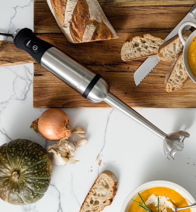 Food product photography - a table with bread, soup and a blender