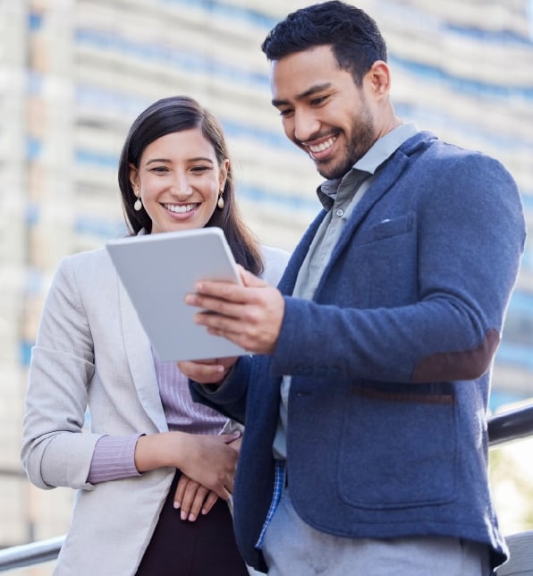 a man and woman standing in front of a building