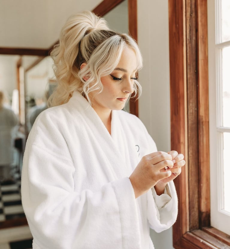 a woman in a white robe is holding a cell phone