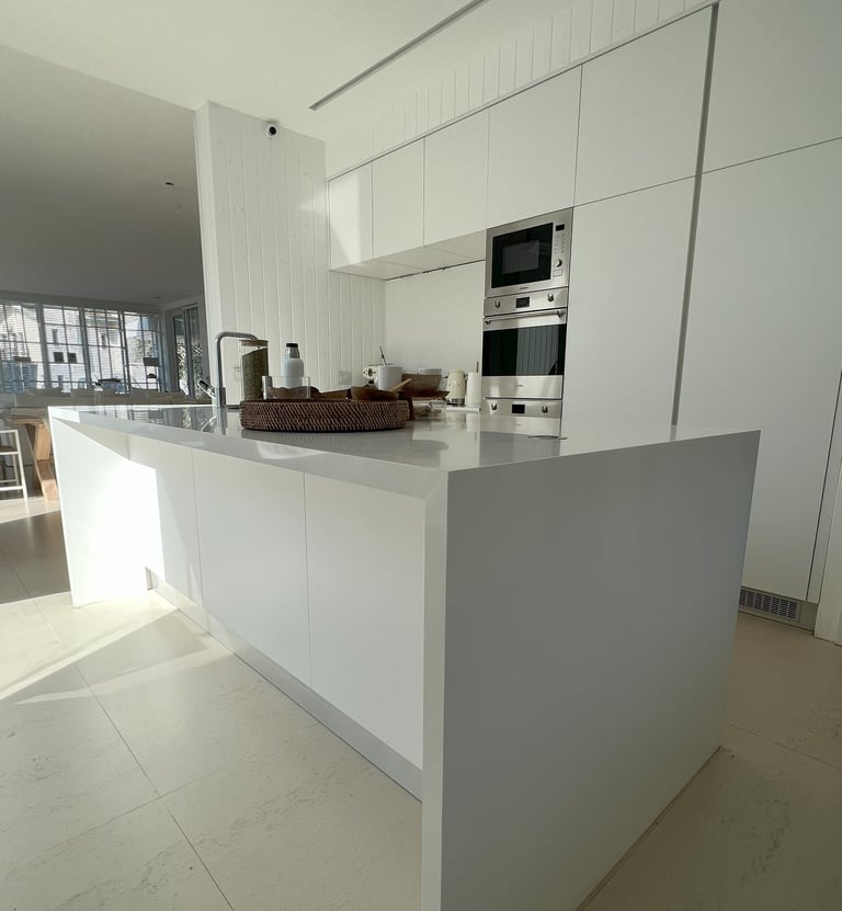 a kitchen with a large island style counter top