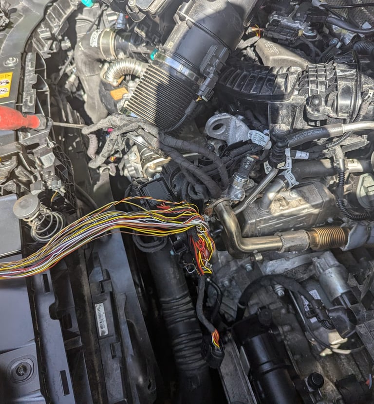 a man working on a car engine in a car