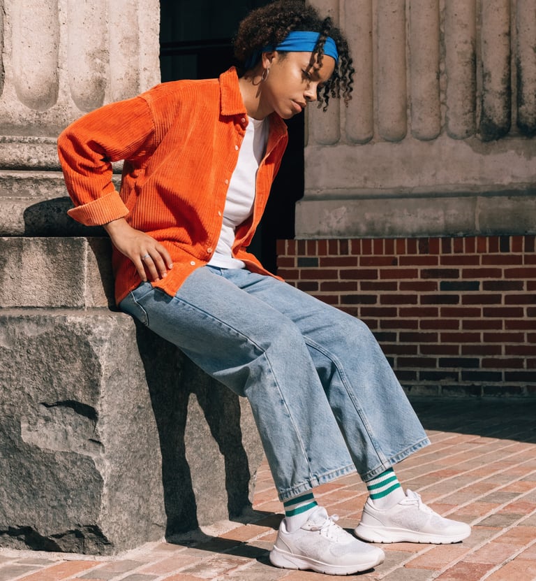 Adult indicating hip and leg area commonly affected by sciatica symptoms