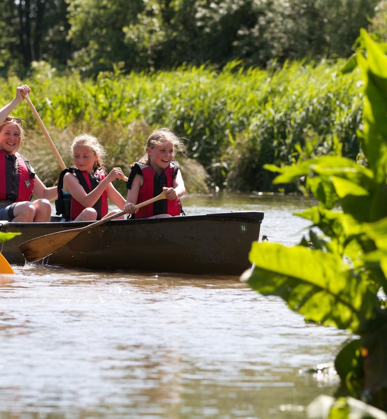a group of people in a canoe on a river