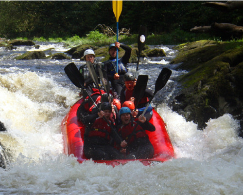 a group of people rafting down a river