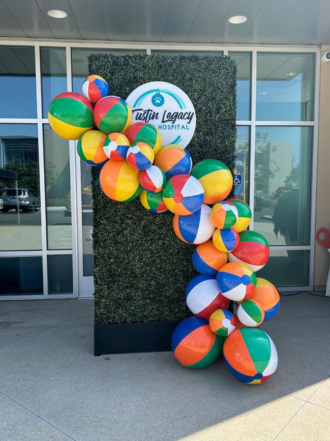 a bunch of balloons and balloons are in front of a building open house party planner