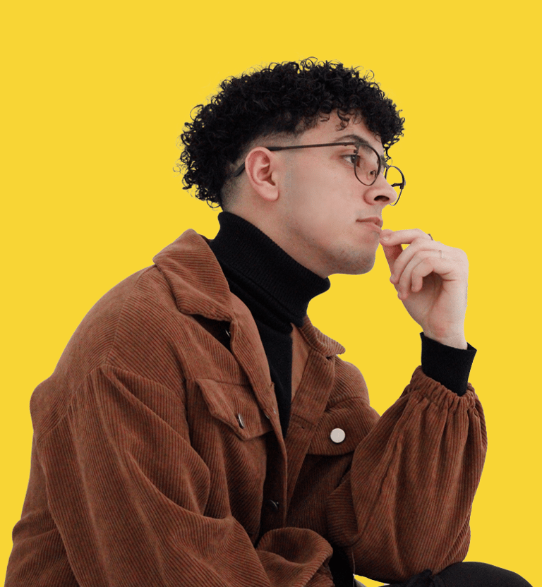 a man in a brown jacket and glasses