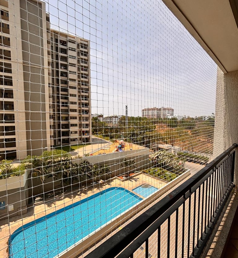 Wide shot showing a multi-story apartment with safety nets preventing unsafe falls