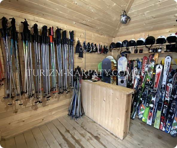 a room with a bunch of skis and snowboards