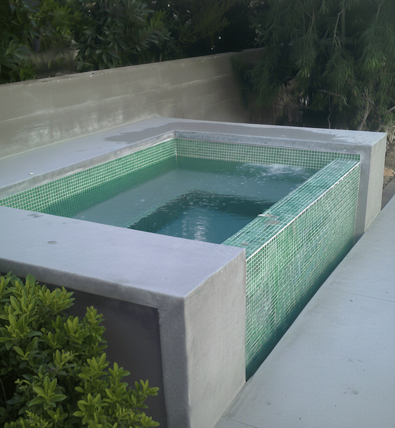tiled spa with water flowing under nearby decking