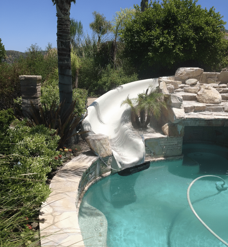 swimming pool with grotto and natural stone slide