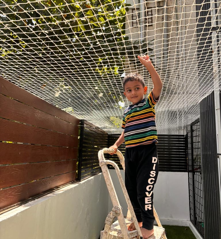 Wide shot of a residential balcony in Tambaram fitted with safety nets to keep children safe