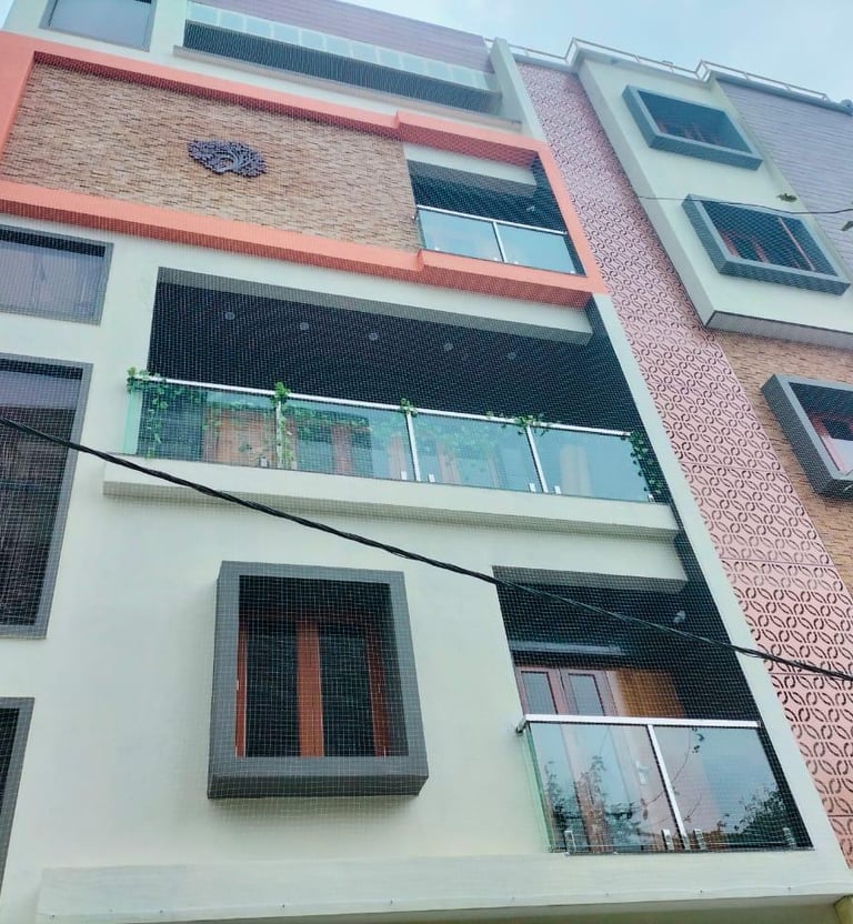 Wide shot showing a high-rise apartment balcony fully covered with a safety net by Arjilli Enterpris